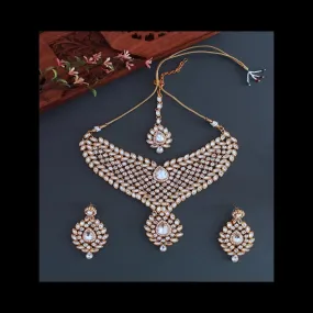 Designer stone studded kundan bridal set with earrings and tikka.